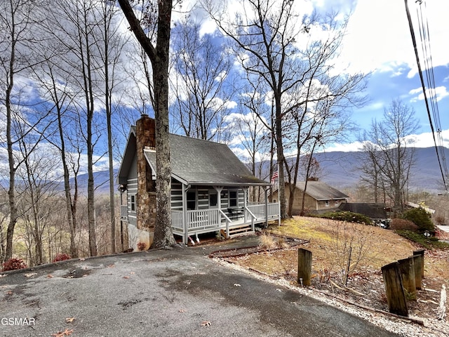 log-style house with a mountain view and a porch