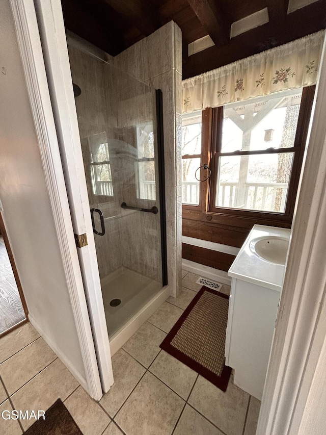 bathroom with tile patterned flooring, vanity, and a shower with shower door