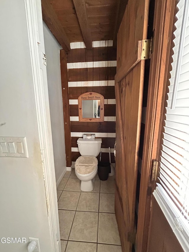 bathroom with tile patterned flooring, toilet, and wood ceiling