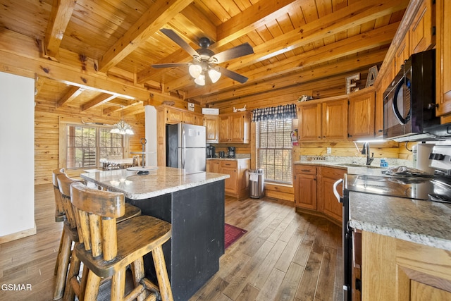 2023 Piney Overlook Ln, Sevierville, TN 37862 - kitchen with stainless steel appliances, wood ceiling, wooden walls, beam ceiling, and wood-type flooring