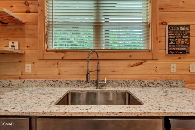 1014 Pinyon Cir, Pigeon Forge, TN 37863 - kitchen view of dishwashing machine, light stone countertops, and wooden walls