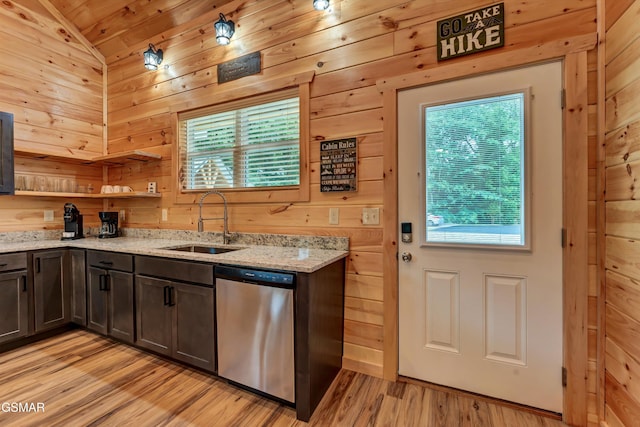 1014 Pinyon Cir, Pigeon Forge, TN 37863 - kitchen featuring dishwasher, vaulted ceiling, light stone countertops, wood walls, and light wood-style flooring