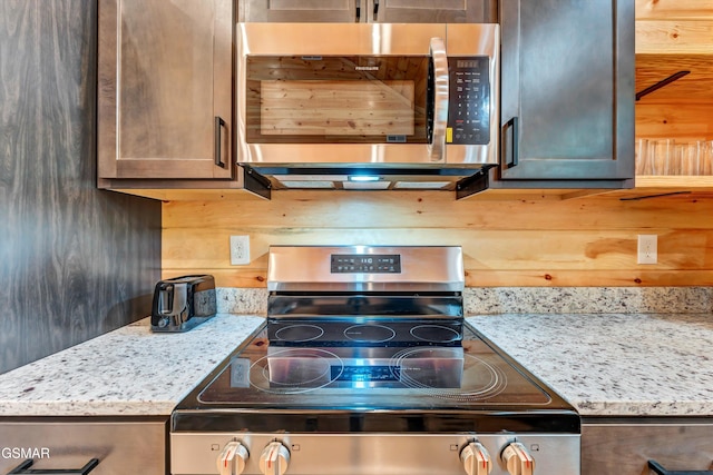 1014 Pinyon Cir, Pigeon Forge, TN 37863 - kitchen featuring stainless steel microwave and light stone counters