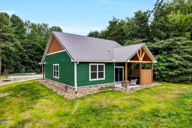 1014 Pinyon Cir, Pigeon Forge, TN 37863 - view of front of property with a front lawn, a patio, and a metal roof
