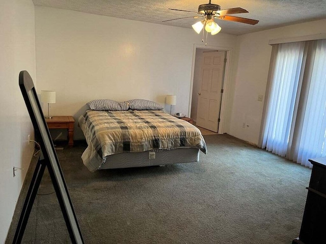 carpeted bedroom featuring ceiling fan and a textured ceiling