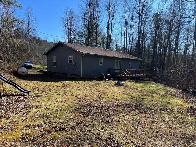 back of house with a wooden deck