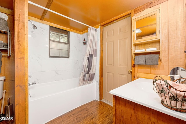 full bathroom with shower / bath combo with shower curtain, toilet, wood-type flooring, and vanity