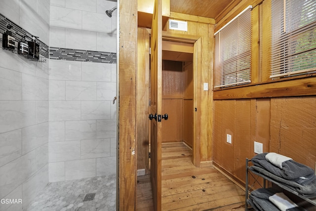 215 Lovers Ln, Townsend, TN 37882 - bathroom featuring hardwood / wood-style floors, a shower stall, and wooden walls