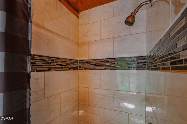 interior details featuring a tile shower