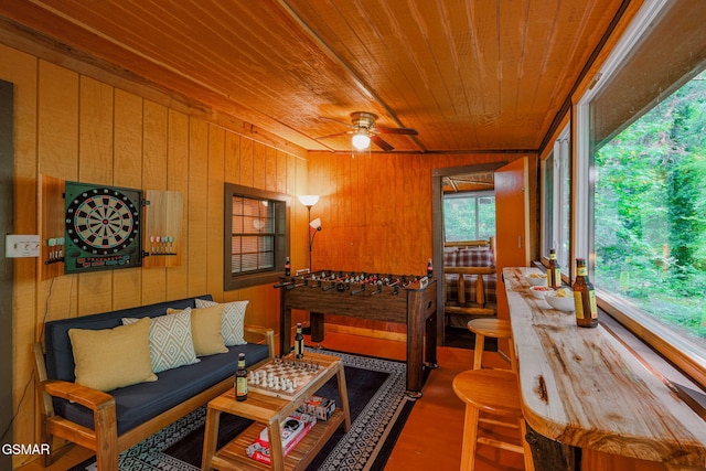 sunroom / solarium with ceiling fan and wooden ceiling