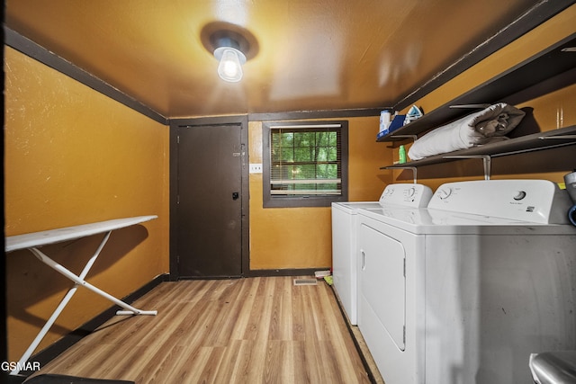 215 Lovers Ln, Townsend, TN 37882 - washroom featuring washing machine and dryer, light wood-style flooring, and baseboards