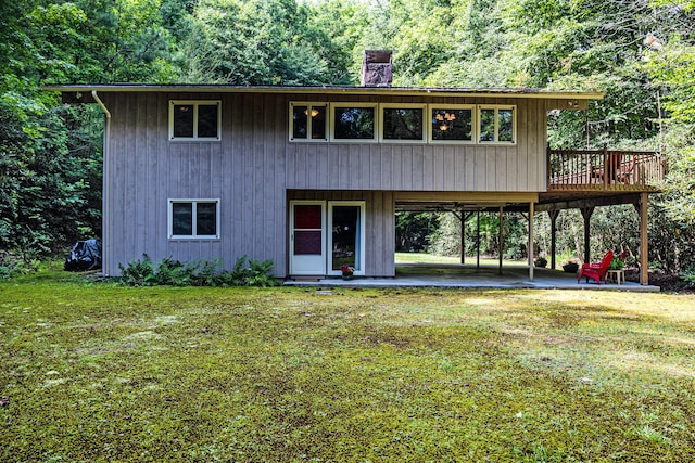 view of property with a wooden deck and a front yard