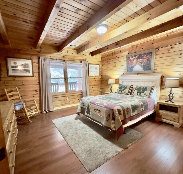 bedroom with beam ceiling, wood ceiling, wooden walls, and wood-type flooring