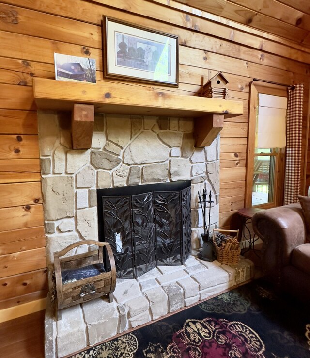 interior details with wood walls and a fireplace