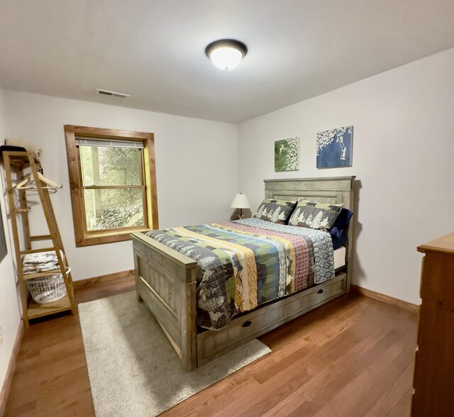 bedroom with hardwood / wood-style flooring