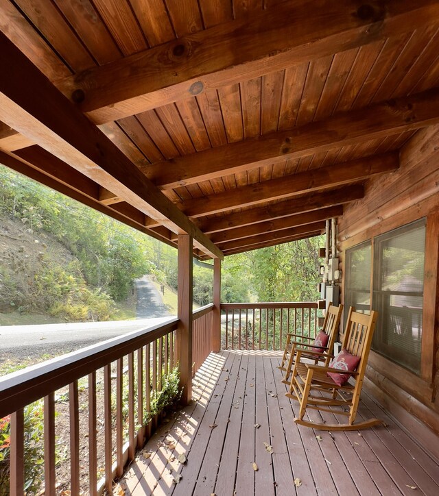 wooden terrace featuring covered porch