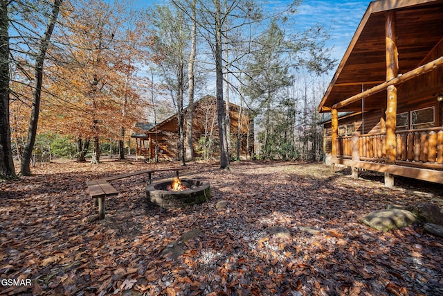 view of yard featuring an outdoor fire pit