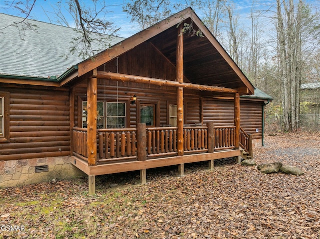 rear view of house featuring covered porch