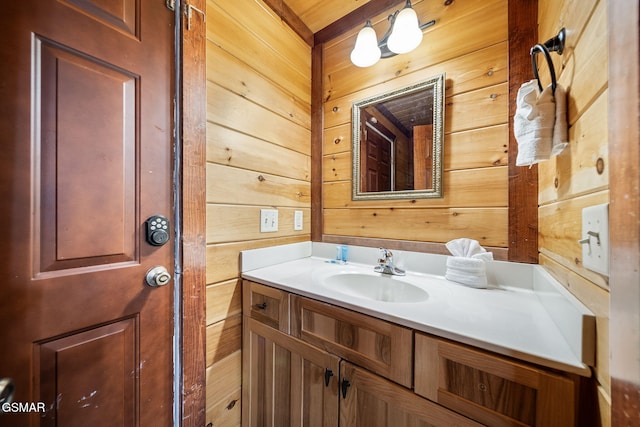 bathroom featuring wood walls and vanity