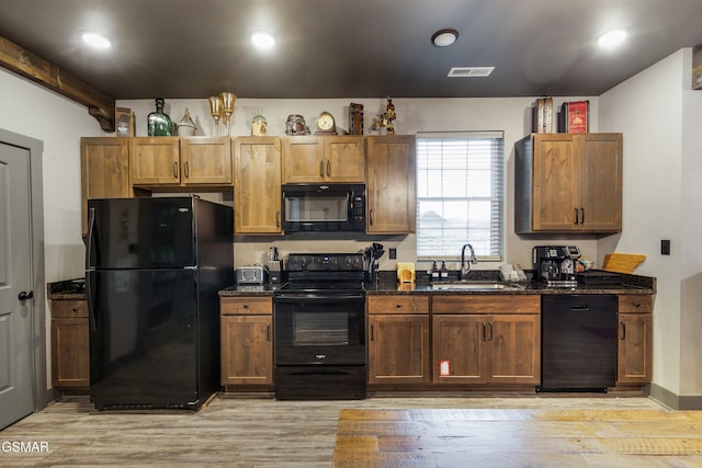 970 Douglas Dam Rd Unit 6, Kodak, TN 37764 - kitchen with black appliances, dark stone counters, light wood finished floors, and recessed lighting