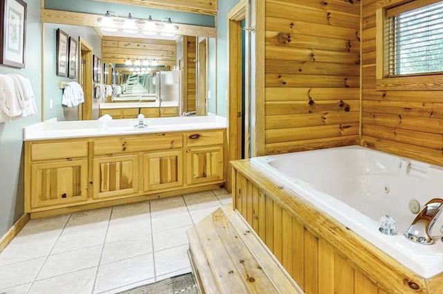 bathroom with tile patterned floors, vanity, and a tub