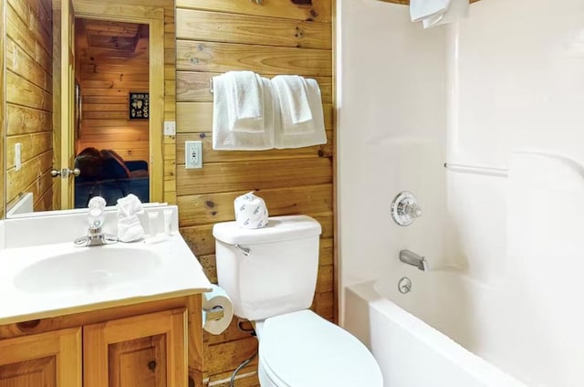 full bathroom with vanity, toilet, shower / bathtub combination, and wood walls