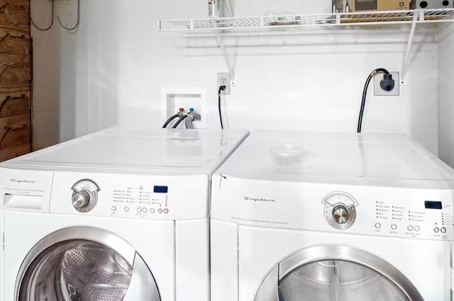 clothes washing area with washer and clothes dryer