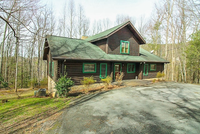 log home featuring central AC unit