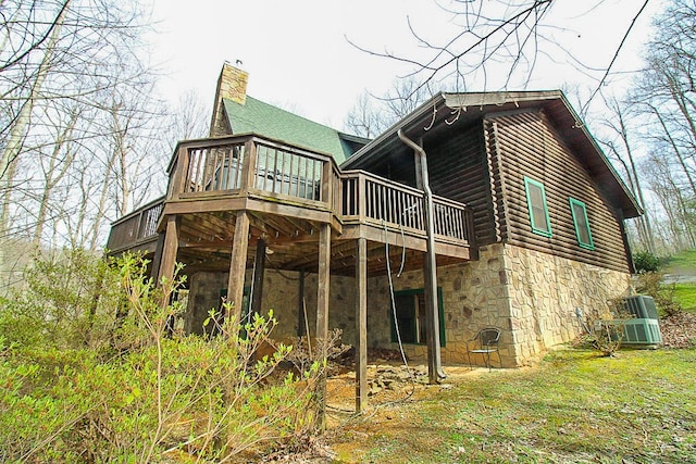 rear view of house with a wooden deck