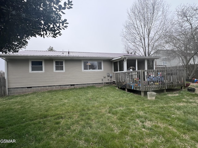 rear view of property featuring fence, a wooden deck, metal roof, a yard, and crawl space