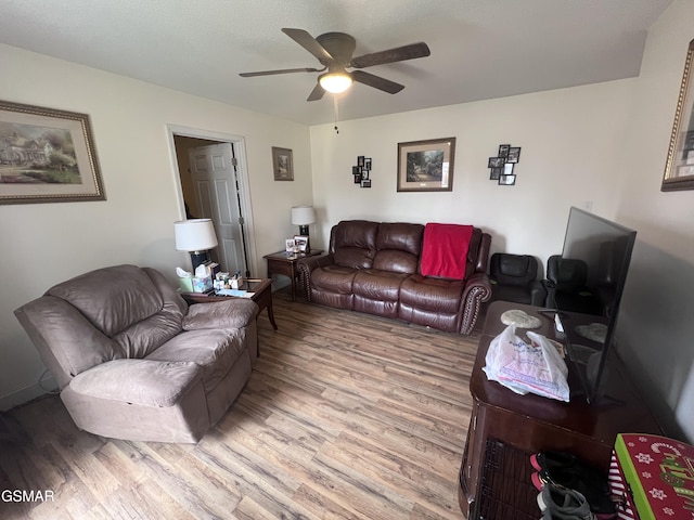 living room with a ceiling fan and wood finished floors