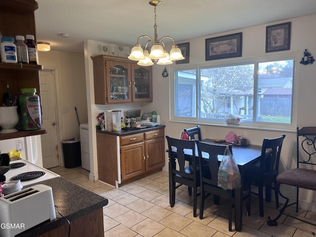 dining area featuring light tile patterned floors and a chandelier