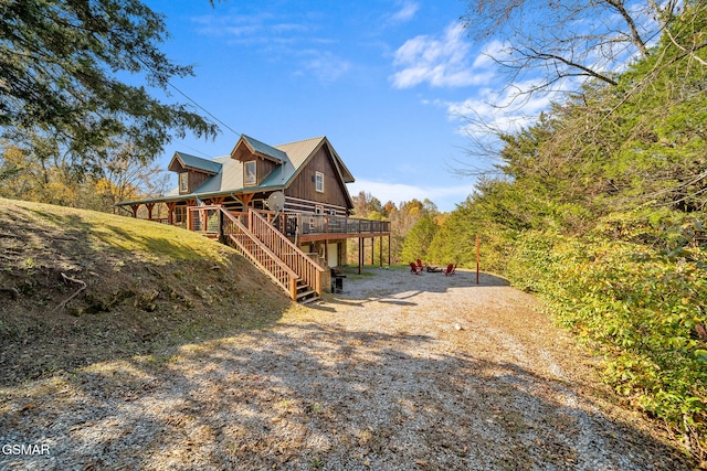 view of property exterior featuring a wooden deck