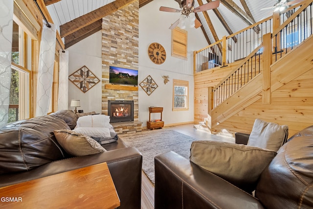 living room featuring a fireplace, hardwood / wood-style floors, high vaulted ceiling, and a wealth of natural light