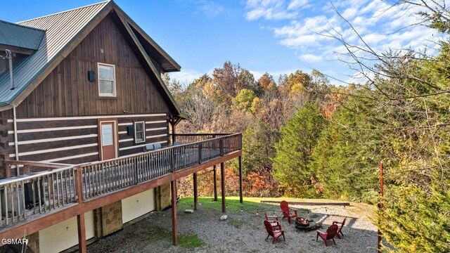 back of property with a garage and a wooden deck