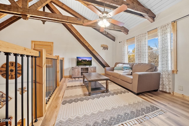 living room with lofted ceiling with beams, light hardwood / wood-style floors, ceiling fan, and wooden ceiling