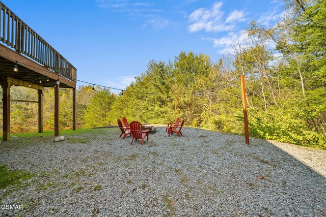 view of yard with a fire pit and a deck