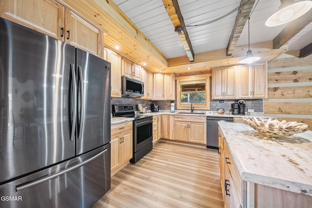 kitchen featuring beam ceiling, sink, light brown cabinets, decorative light fixtures, and appliances with stainless steel finishes