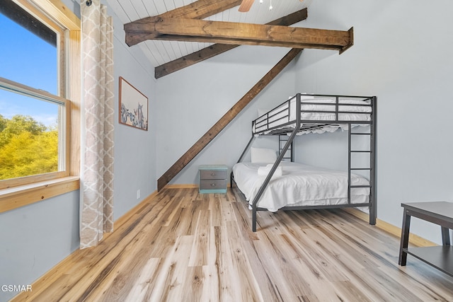 unfurnished bedroom with vaulted ceiling with beams, ceiling fan, wood ceiling, and light wood-type flooring