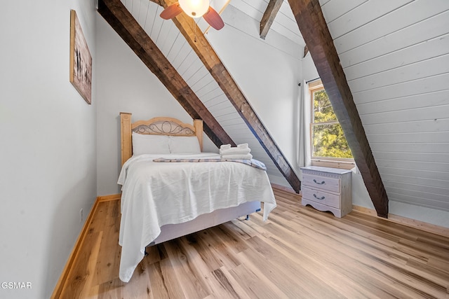 bedroom with ceiling fan, light hardwood / wood-style flooring, and lofted ceiling with beams