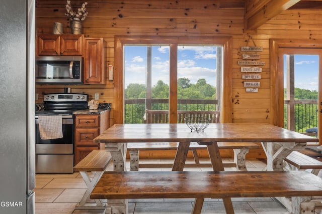 2083 Kerr Rd, Sevierville, TN 37876 - kitchen with stainless steel appliances, wooden walls, and brown cabinetry