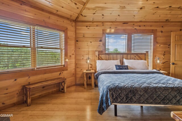 2083 Kerr Rd, Sevierville, TN 37876 - bedroom with multiple windows, light wood-style flooring, wooden walls, and wood ceiling