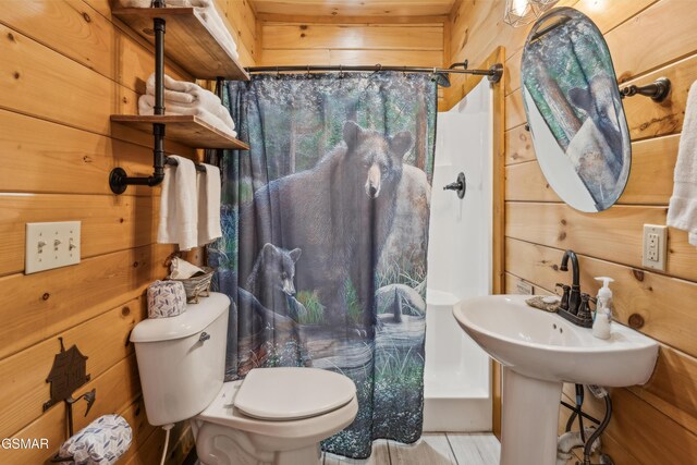 2083 Kerr Rd, Sevierville, TN 37876 - bathroom featuring curtained shower, toilet, and wood walls