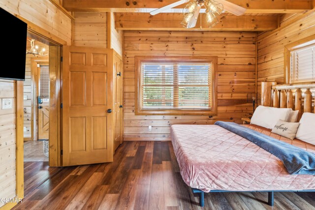 2083 Kerr Rd, Sevierville, TN 37876 - bedroom featuring wood walls, beam ceiling, and dark wood-style flooring