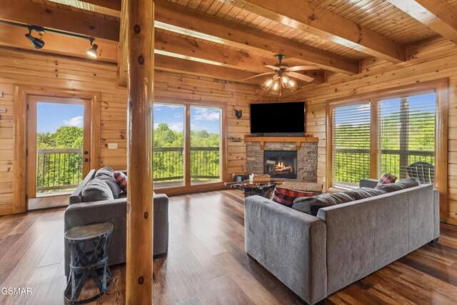 2083 Kerr Rd, Sevierville, TN 37876 - living area featuring wood ceiling, rail lighting, a ceiling fan, a fireplace, and beamed ceiling