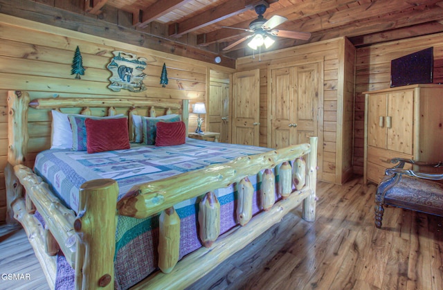 3529 Peggy Ln, Pigeon Forge, TN 37863 - bedroom featuring wooden ceiling with exposed beams, wood finished floors, wood walls, and a ceiling fan