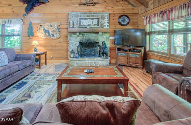 3529 Peggy Ln, Pigeon Forge, TN 37863 - living room with wooden walls, a fireplace, vaulted ceiling, and wood finished floors