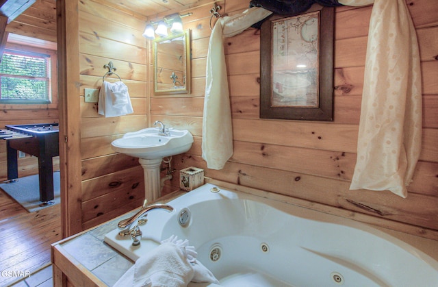 3529 Peggy Ln, Pigeon Forge, TN 37863 - bathroom with a whirlpool tub, wood walls, and wood finished floors