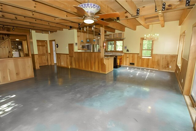 interior space with a wainscoted wall, freestanding refrigerator, and wooden walls