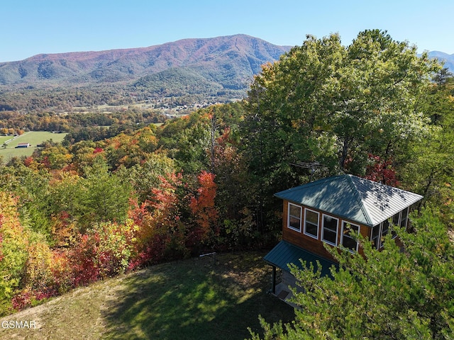 exterior space featuring a wooded view